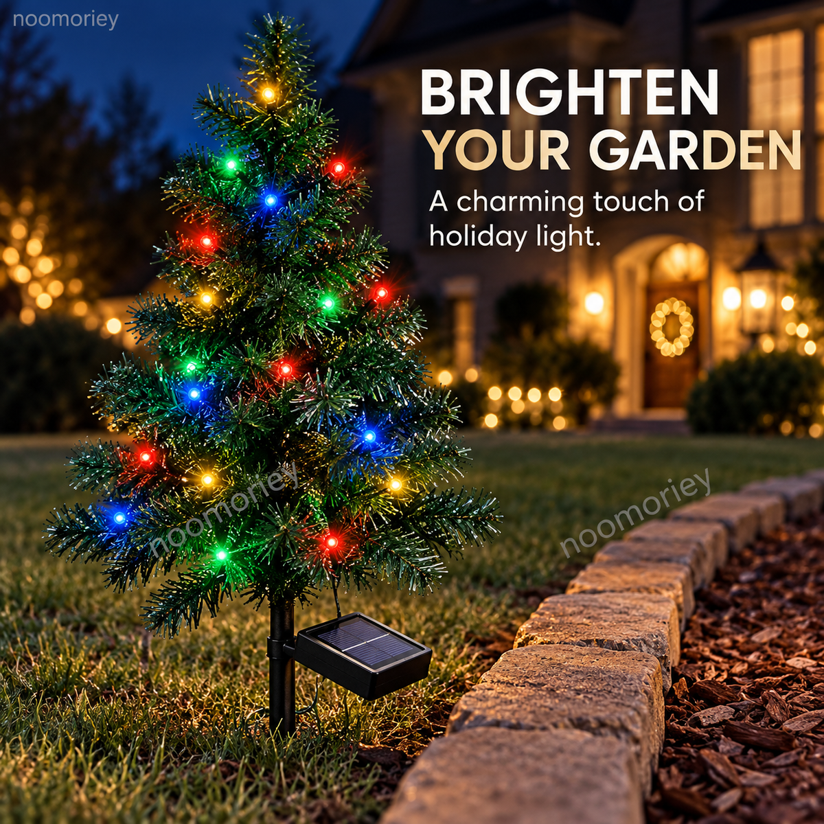 Close view of a mini solar Christmas tree with its panel placed beside a garden border