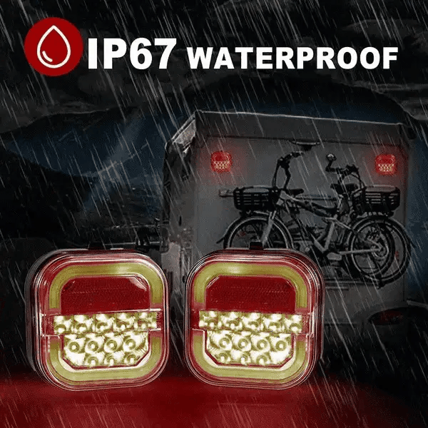 Pair of red and amber trailer LED lights shown in heavy rain with IP67 protection labeling